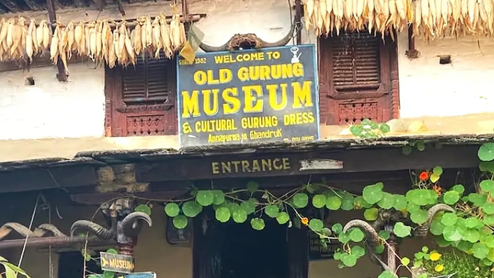 Entrance to the Old Gurung Museum in Ghandruk, showcasing traditional Gurung culture and attire.